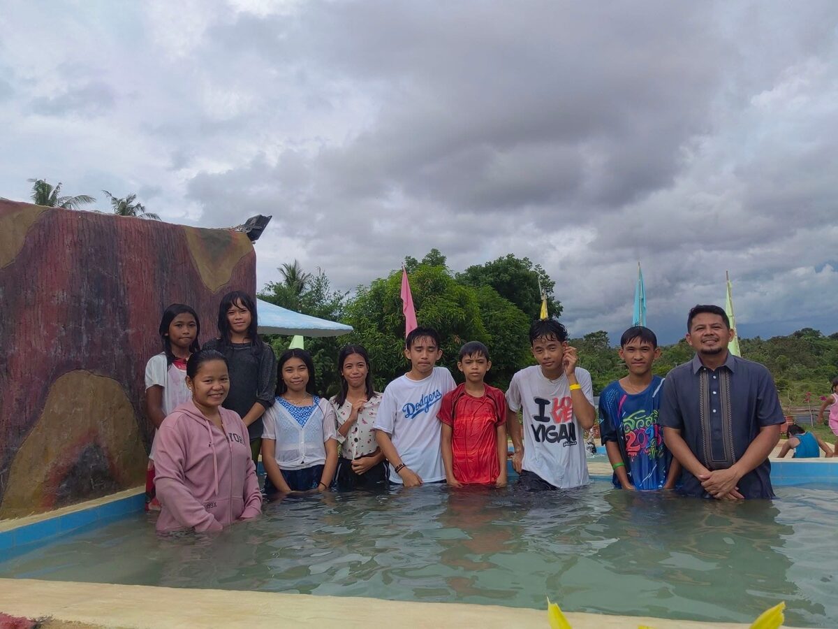 Pastor Melfer with believers being baptized